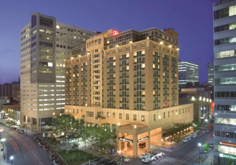 The outside of the hotel at night.